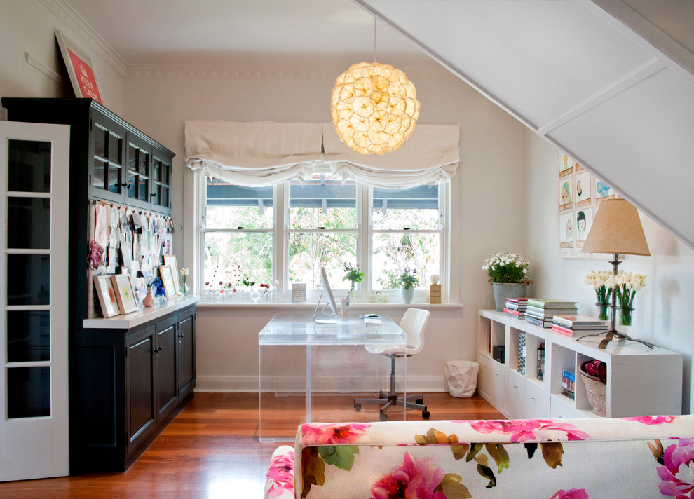 Photo of a small eclectic study room in Perth with white walls, medium hardwood floors and a freestanding desk.