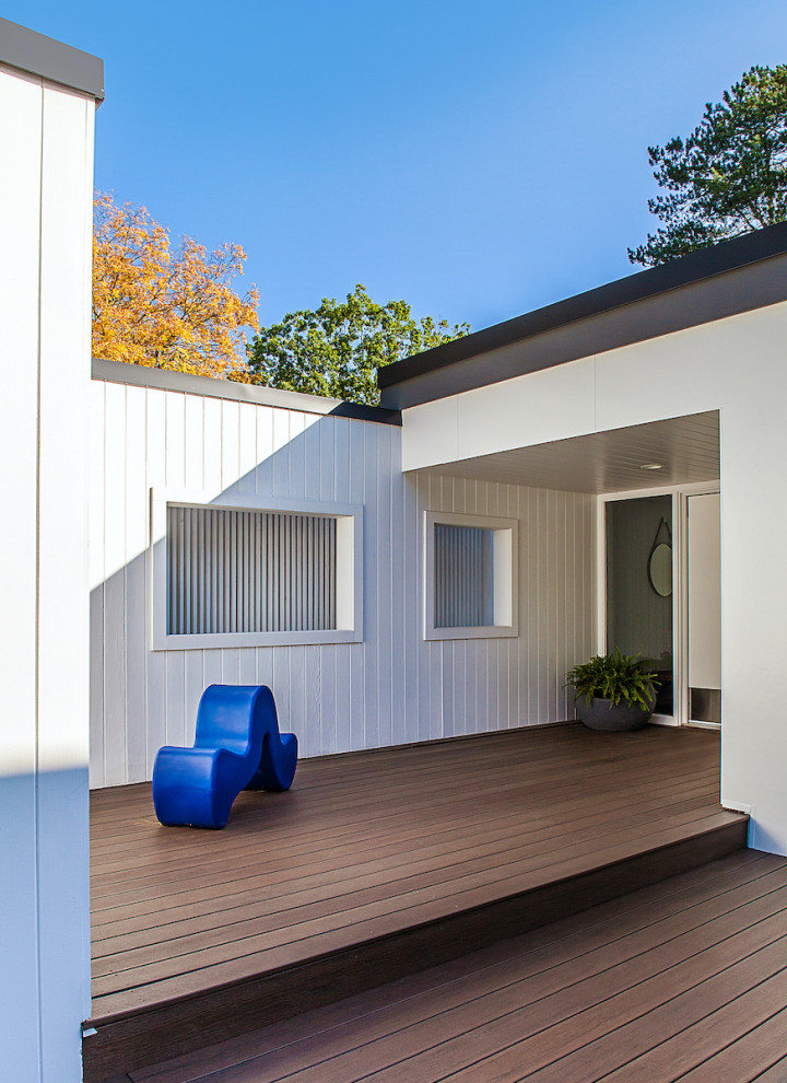 Inspiration pour un porche d'entrée de maison avant vintage de taille moyenne avec une terrasse en bois et une extension de toiture.