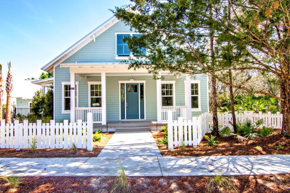 Photo of a mid-sized beach style two-storey blue exterior in Jacksonville with vinyl siding and a gable roof.