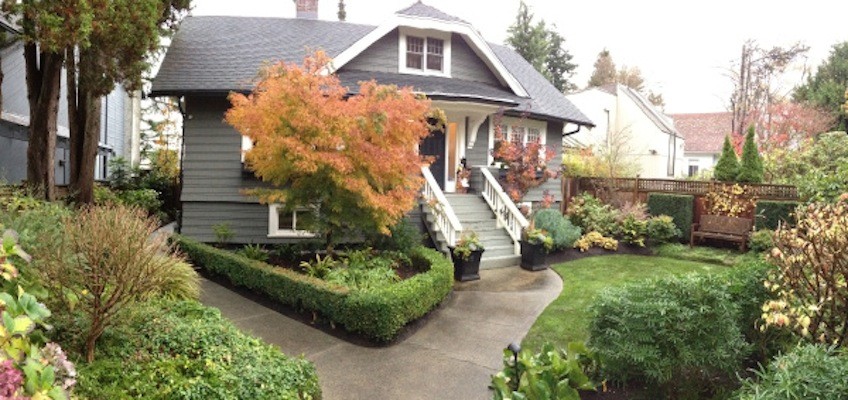 Photo of a mid-sized traditional front yard partial sun garden in Vancouver with a garden path and concrete pavers.