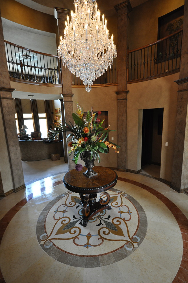 Photo of a large traditional foyer in Dallas with beige walls, travertine floors, a double front door and a dark wood front door.