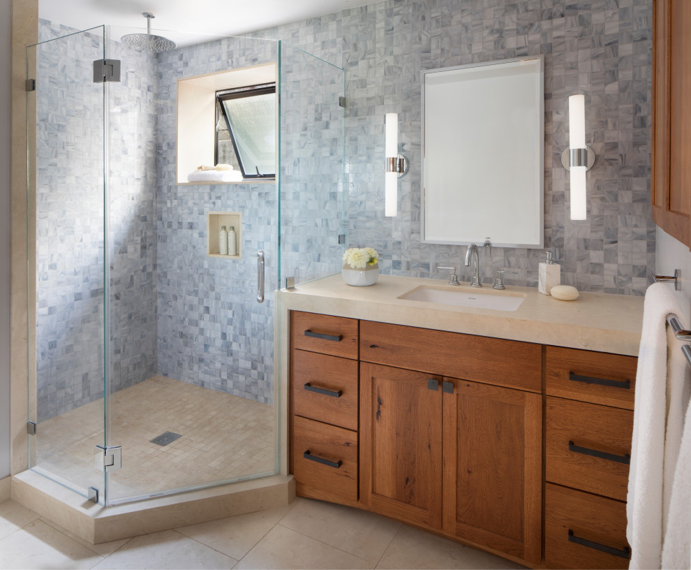 Inspiration for a mid-sized transitional master bathroom in San Francisco with flat-panel cabinets, a corner shower, multi-coloured tile, mosaic tile, multi-coloured walls, marble floors, an undermount sink, marble benchtops, beige floor, a hinged shower door, beige benchtops, a shower seat, a single vanity, a built-in vanity, recessed and brown cabinets.