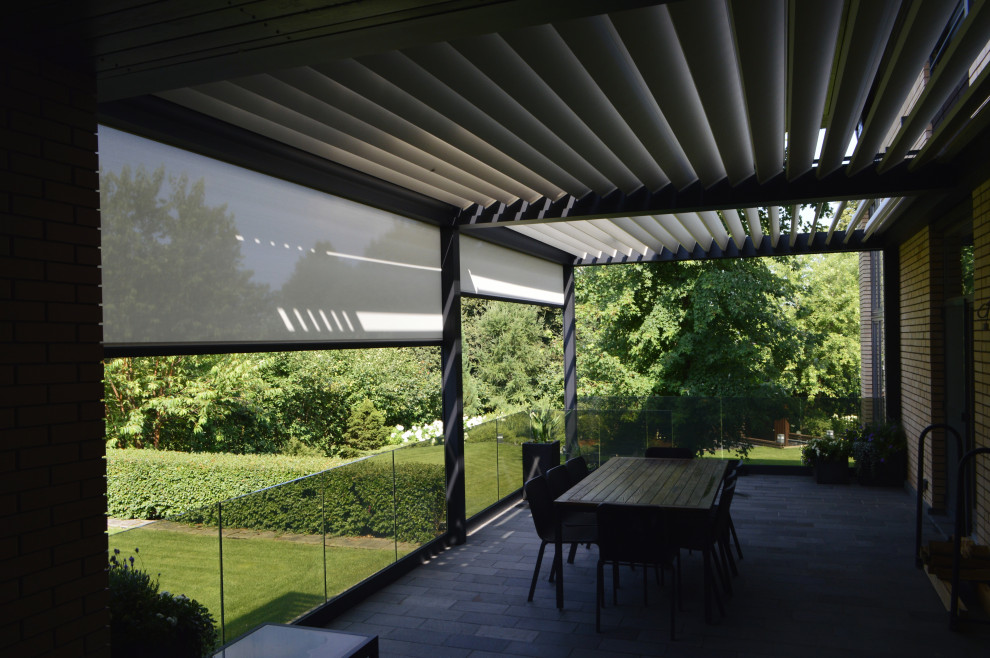 Inspiration for a contemporary backyard verandah in Other with a pergola and glass railing.