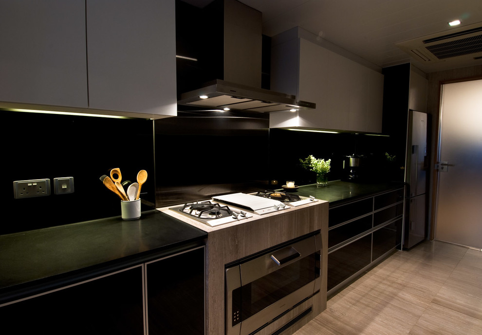 This is an example of a mid-sized asian u-shaped separate kitchen in Hong Kong with a double-bowl sink, flat-panel cabinets, black cabinets, granite benchtops, black splashback, glass sheet splashback, stainless steel appliances and marble floors.