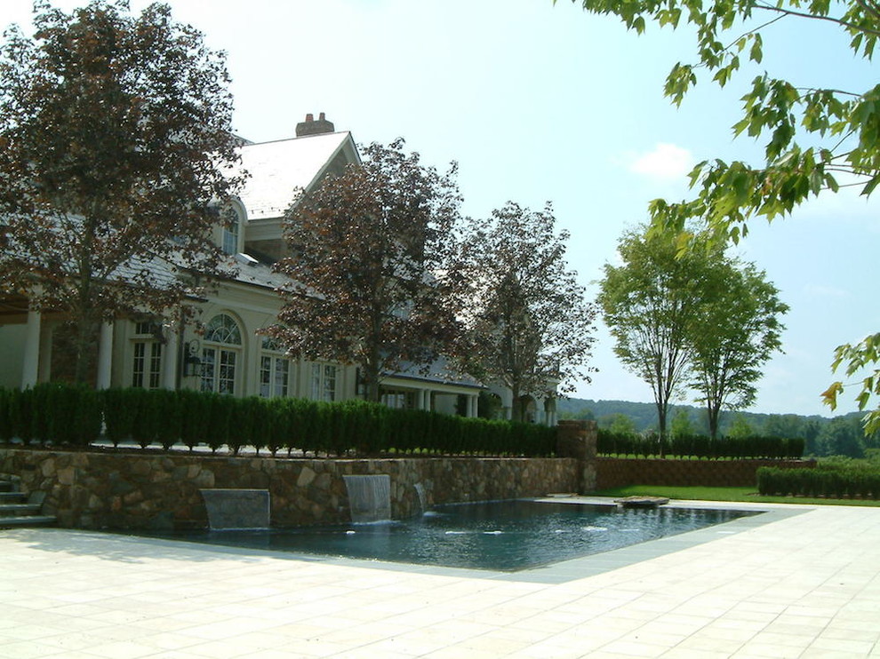 Mid-sized backyard stone and rectangular lap pool fountain photo in Baltimore