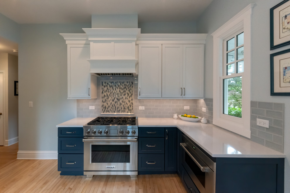 Kitchen - large transitional medium tone wood floor kitchen idea in Chicago with an undermount sink, shaker cabinets, blue cabinets, quartz countertops, blue backsplash, subway tile backsplash, paneled appliances, no island and white countertops