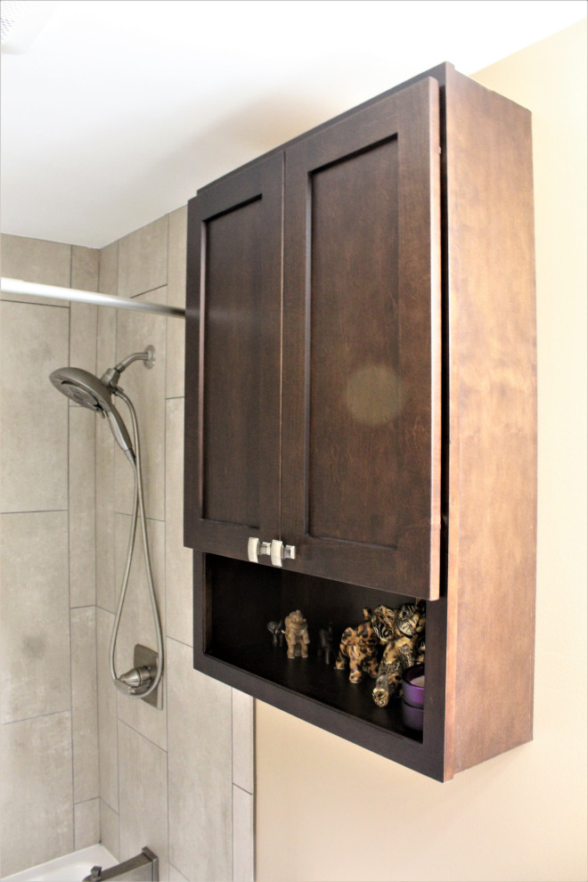 Inspiration for a mid-sized transitional master bathroom in Detroit with shaker cabinets, brown cabinets, an alcove tub, an alcove shower, beige tile, ceramic tile, beige walls, porcelain floors, an undermount sink, granite benchtops, brown floor, a shower curtain, brown benchtops, a single vanity and a freestanding vanity.