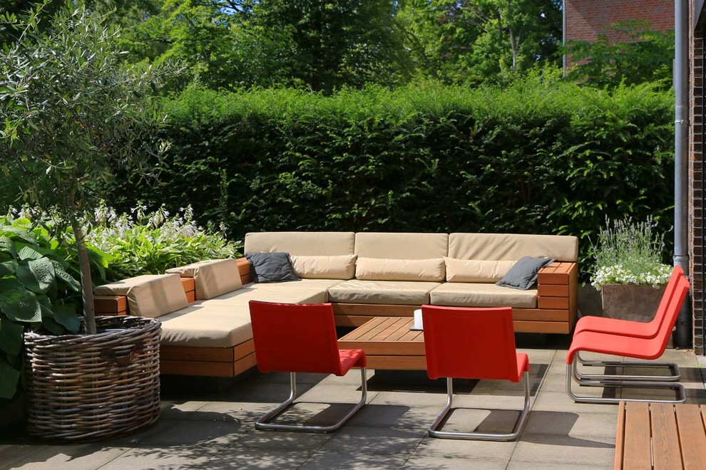 This is an example of a large contemporary backyard patio in Hamburg with a container garden and no cover.