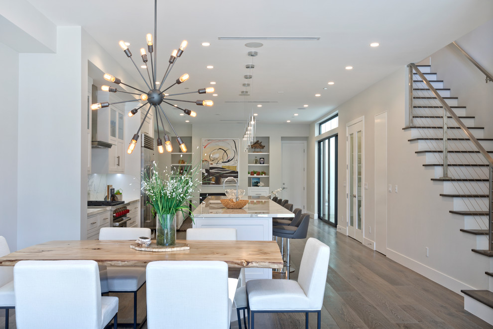Design ideas for a mid-sized modern open plan dining in Orange County with white walls, light hardwood floors, no fireplace and beige floor.