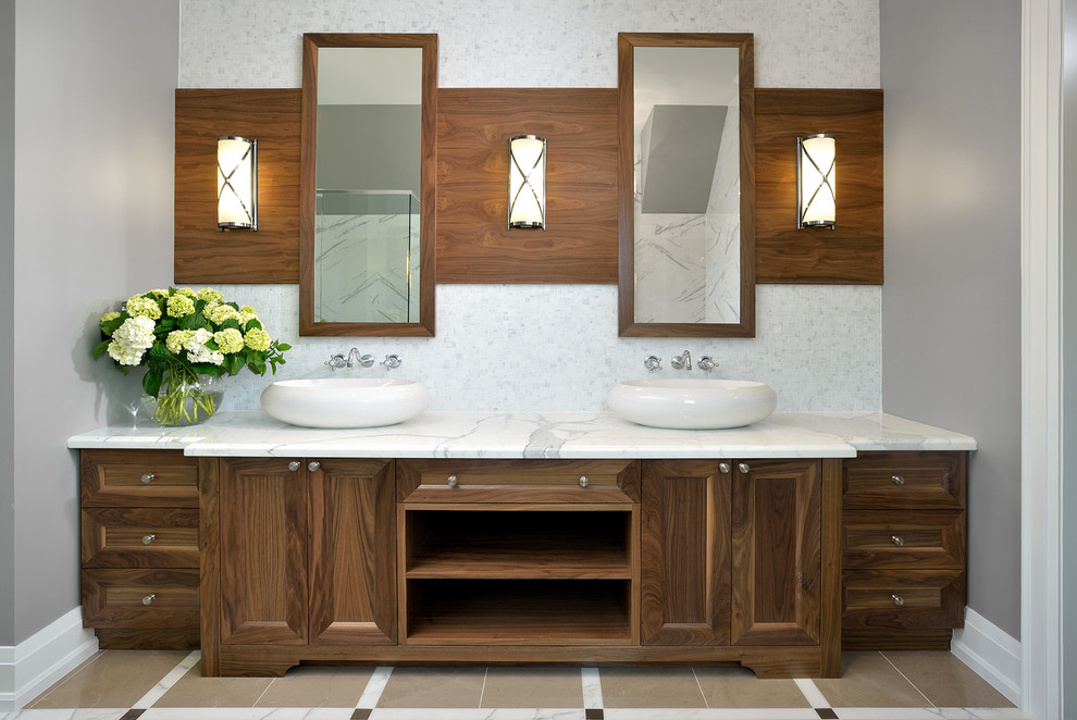 This is an example of a traditional bathroom in Toronto with a vessel sink, recessed-panel cabinets, dark wood cabinets, marble benchtops and grey walls.