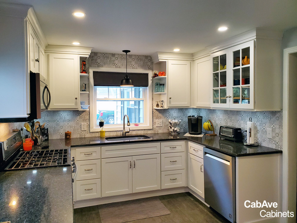 Small transitional u-shaped dark wood floor and gray floor eat-in kitchen photo in New York with an undermount sink, shaker cabinets, white cabinets, granite countertops, multicolored backsplash, porcelain backsplash, stainless steel appliances, no island and black countertops