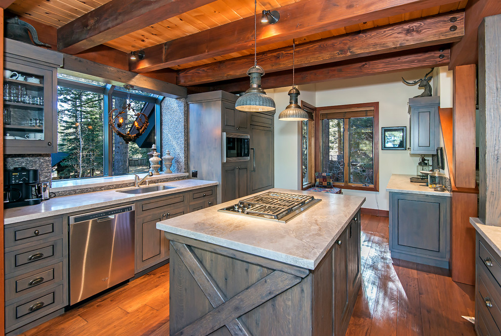 Kitchen - rustic medium tone wood floor kitchen idea with a single-bowl sink, quartzite countertops, stainless steel appliances and an island
