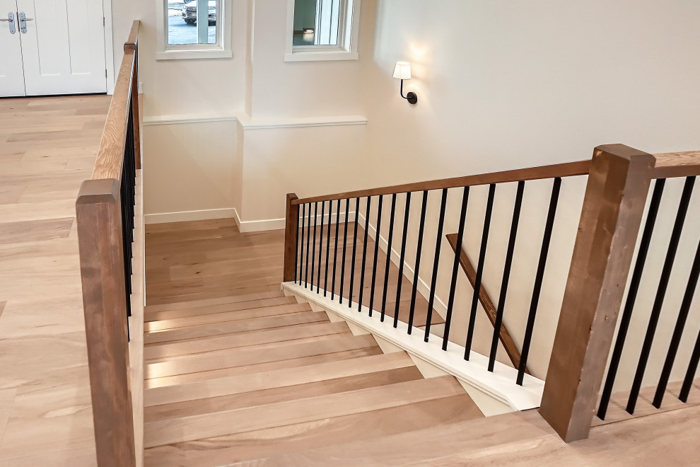 Large cottage wooden u-shaped wood railing staircase photo in Denver with wooden risers