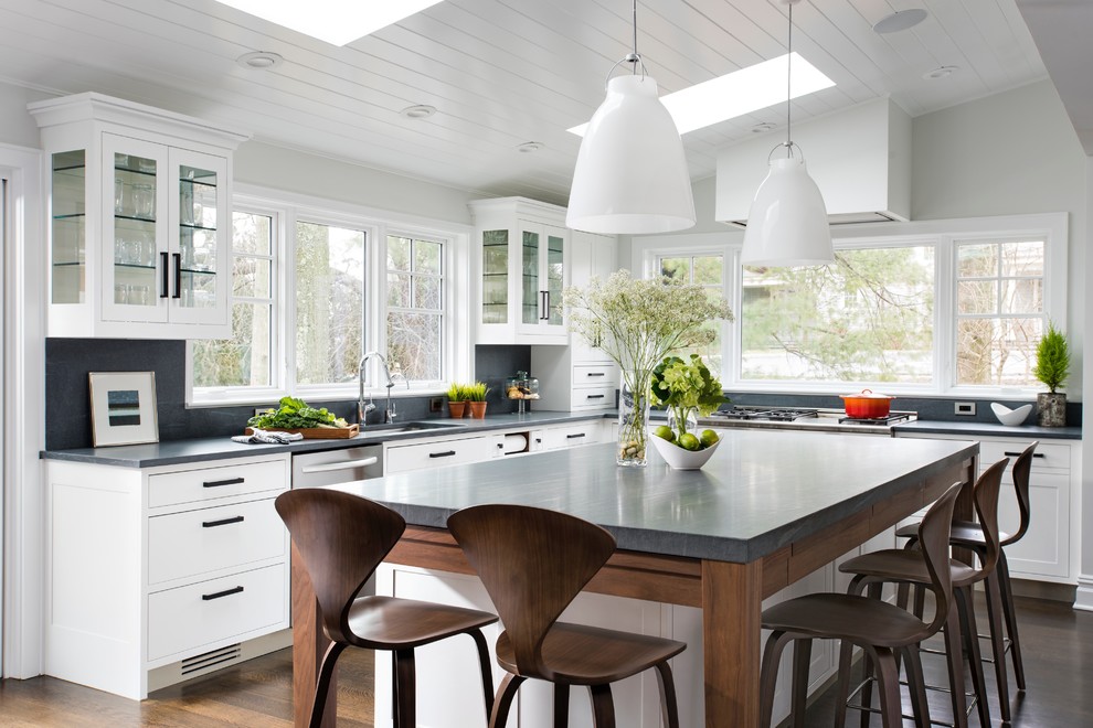 Inspiration for a large transitional eat-in kitchen in New York with glass-front cabinets, white cabinets, limestone benchtops and with island.