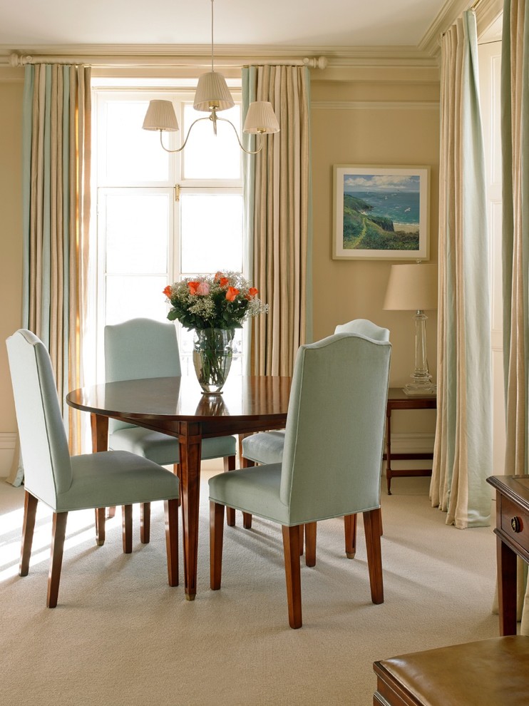 This is an example of a dining room in London with beige walls and carpet.