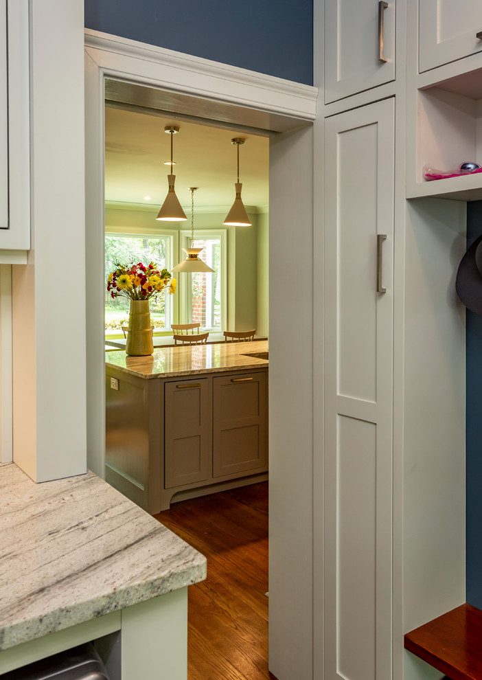 Inspiration for a small traditional galley utility room in Charlotte with an undermount sink, recessed-panel cabinets, grey cabinets, marble benchtops, blue walls, medium hardwood floors, a side-by-side washer and dryer, brown floor and multi-coloured benchtop.