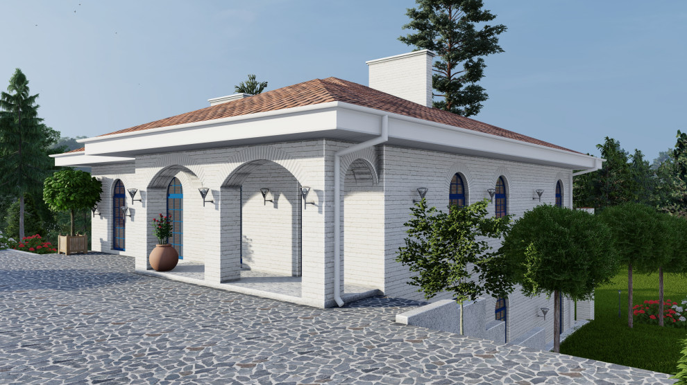 Дом в средиземноморском стиле на участке с уклоном.