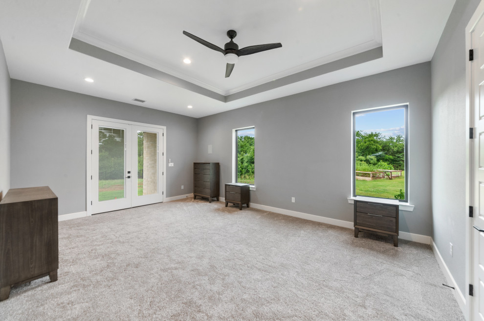 Photo of a large contemporary master bedroom in Dallas with grey walls, carpet, grey floor and coffered.