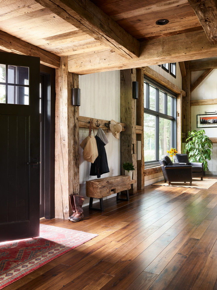 Inspiration for a mid-sized rustic dark wood floor, brown floor, wood ceiling and wood wall entryway remodel in Boston with a black front door