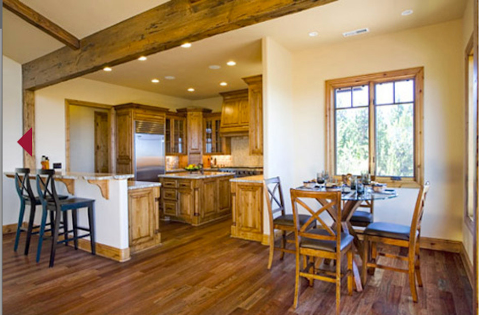 Eat-in kitchen - mid-sized rustic u-shaped medium tone wood floor eat-in kitchen idea with an undermount sink, shaker cabinets, medium tone wood cabinets, granite countertops, beige backsplash, ceramic backsplash, stainless steel appliances and an island