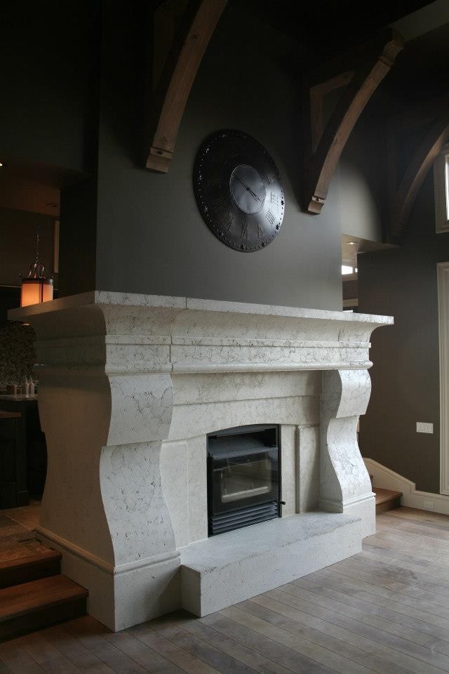 Inspiration for a traditional living room in Calgary with a concrete fireplace surround.