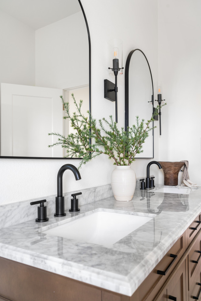 Design ideas for a mid-sized modern bathroom in Dallas with shaker cabinets, brown cabinets, porcelain floors, an undermount sink, marble benchtops, grey floor, grey benchtops, a double vanity and a freestanding vanity.