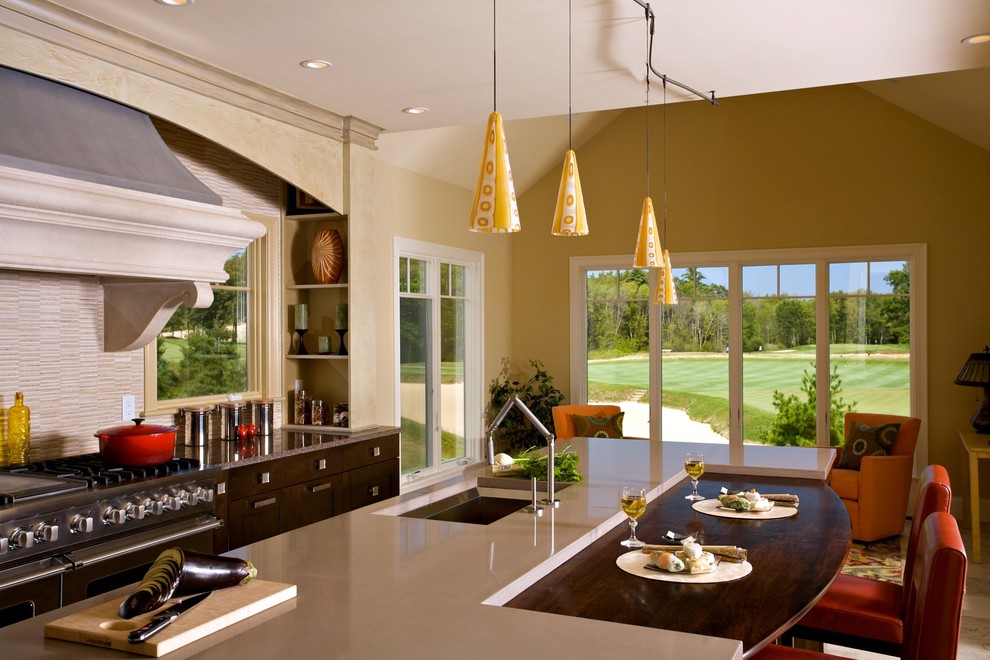 Inspiration for a transitional l-shaped travertine floor eat-in kitchen remodel in Boston with recessed-panel cabinets, dark wood cabinets, concrete countertops, beige backsplash, stone tile backsplash, paneled appliances, gray walls and an island