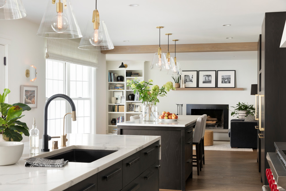 Inspiration for a transitional medium tone wood floor and brown floor kitchen remodel in Minneapolis with a single-bowl sink, flat-panel cabinets, dark wood cabinets, quartz countertops, ceramic backsplash, paneled appliances and two islands