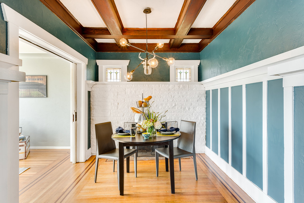 Photo of an arts and crafts dining room in Seattle with multi-coloured walls and medium hardwood floors.