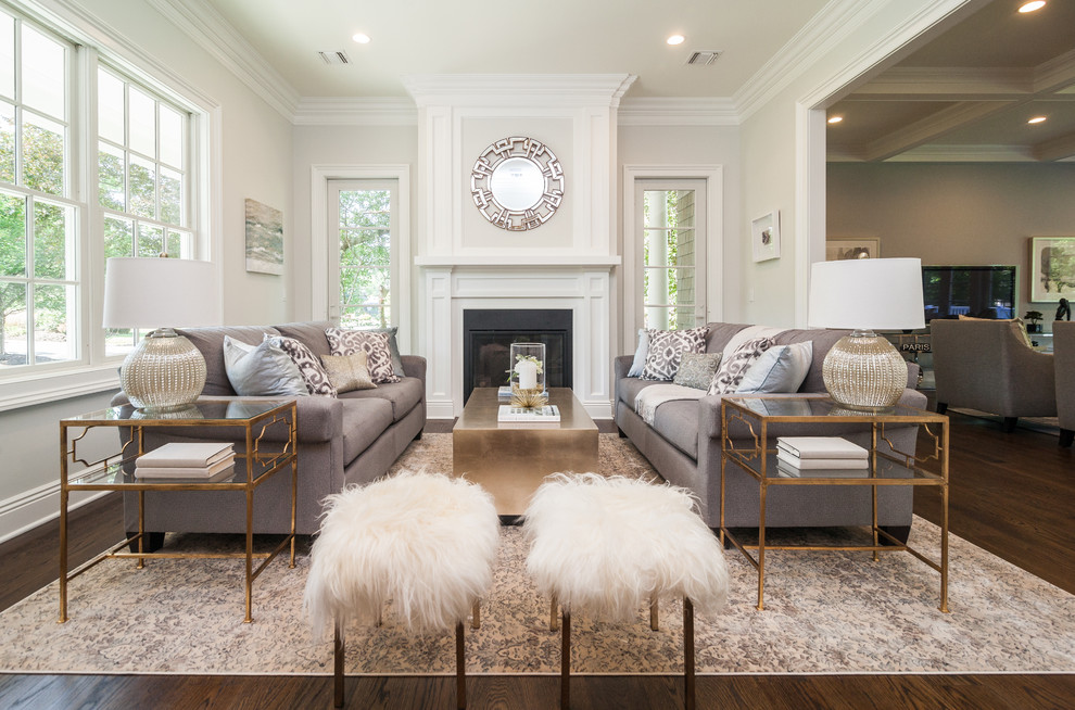 This is an example of a transitional formal open concept living room in New York with white walls, dark hardwood floors, a standard fireplace and no tv.