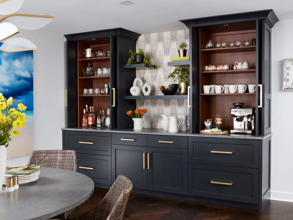 Large transitional single-wall home bar in New York with shaker cabinets, black cabinets, quartz benchtops, white splashback, engineered quartz splashback, painted wood floors, brown floor and grey benchtop.