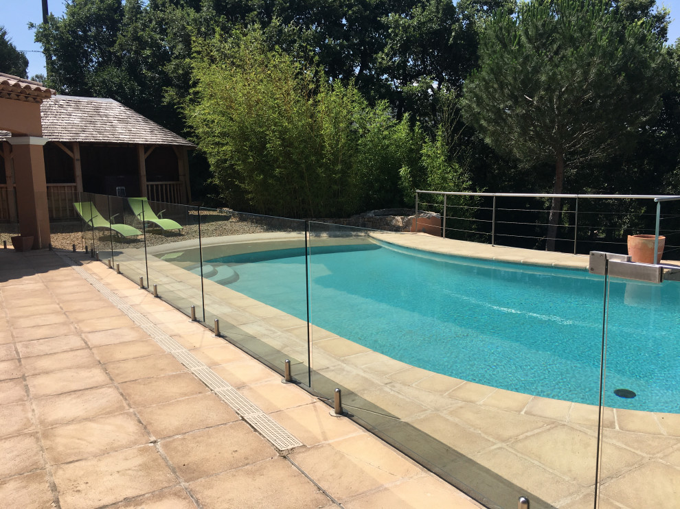 Imagen de piscina minimalista grande en patio trasero con suelo de baldosas