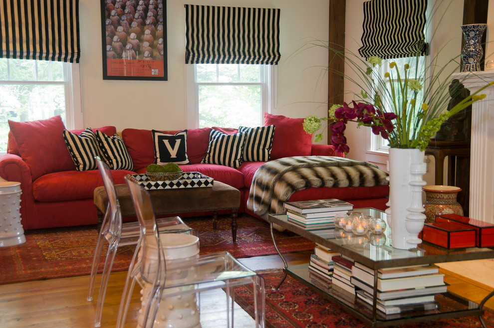 Mid-sized elegant open concept medium tone wood floor family room photo in Boston with beige walls, a standard fireplace, a plaster fireplace and no tv