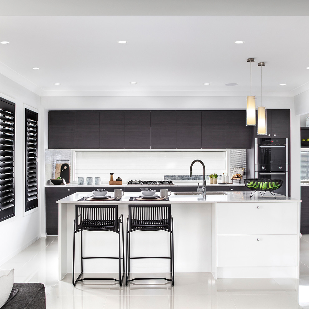 Inspiration for a mid-sized contemporary galley kitchen in Wollongong with an undermount sink, shaker cabinets, marble benchtops, glass sheet splashback, black appliances, ceramic floors, with island, white floor and white benchtop.