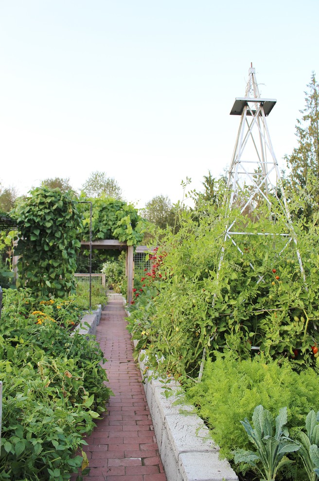 Country full sun garden in Seattle with a vegetable garden and brick pavers.