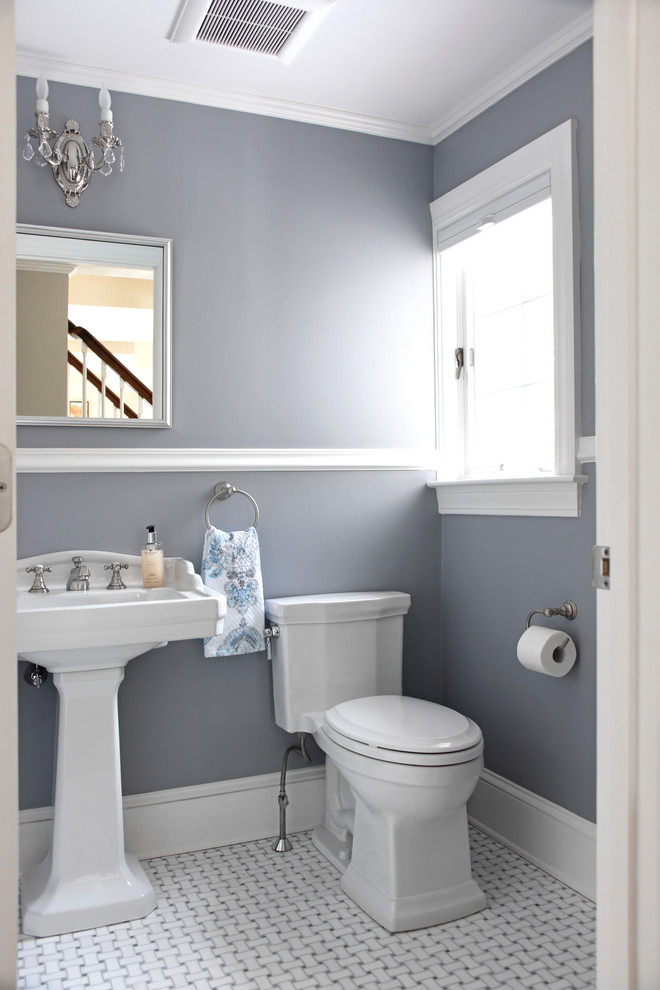 This is an example of a mid-sized traditional powder room in Providence with a one-piece toilet, gray tile, blue walls, ceramic floors, multi-coloured floor and a pedestal sink.