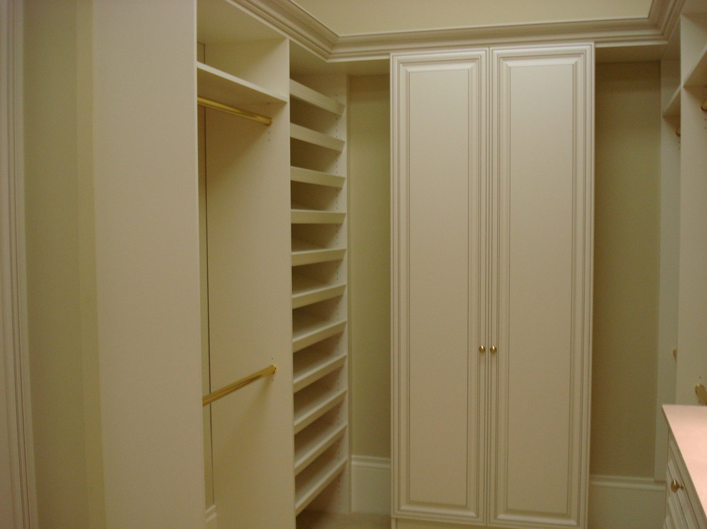 Design ideas for a large contemporary gender-neutral walk-in wardrobe in Miami with white cabinets.