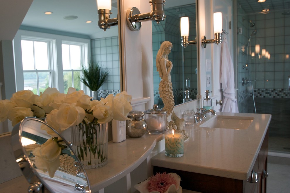 Inspiration for a mid-sized traditional master bathroom in Providence with shaker cabinets, dark wood cabinets, blue tile, ceramic tile, solid surface benchtops, a drop-in tub, a corner shower, an undermount sink, white walls and ceramic floors.