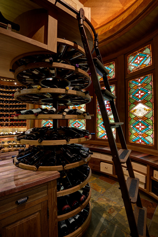 Photo of a traditional wine cellar in Denver with slate floors and storage racks.