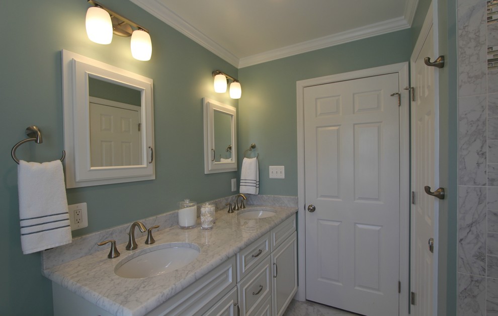 Design ideas for a mid-sized transitional master bathroom in Baltimore with recessed-panel cabinets, white cabinets, an alcove tub, a shower/bathtub combo, a two-piece toilet, gray tile, multi-coloured tile, white tile, stone tile, green walls, marble floors, an undermount sink, marble benchtops, grey floor, white benchtops, a niche, a double vanity and a built-in vanity.