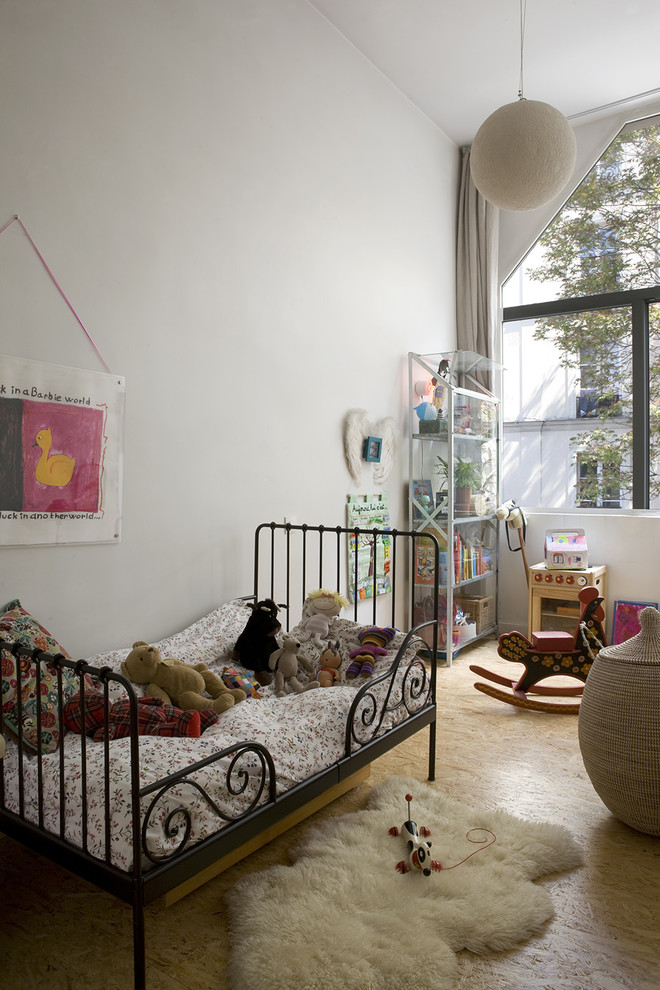 This is an example of a contemporary gender-neutral kids' room in Paris with white walls.
