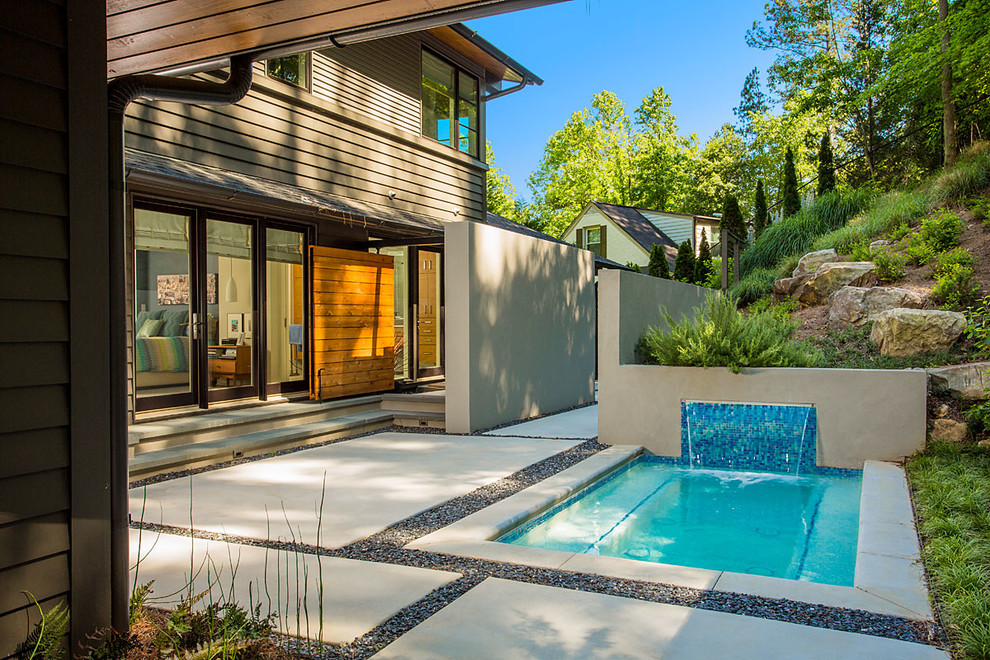 Inspiration for a mid-sized contemporary courtyard rectangular natural pool in Atlanta with a hot tub and concrete slab.