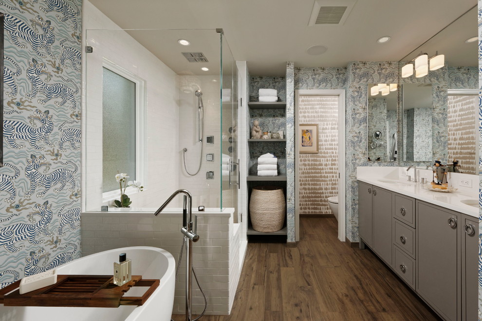 Inspiration for a transitional master bathroom in DC Metro with flat-panel cabinets, grey cabinets, a freestanding tub, a corner shower, multi-coloured walls, dark hardwood floors, an undermount sink and a hinged shower door.