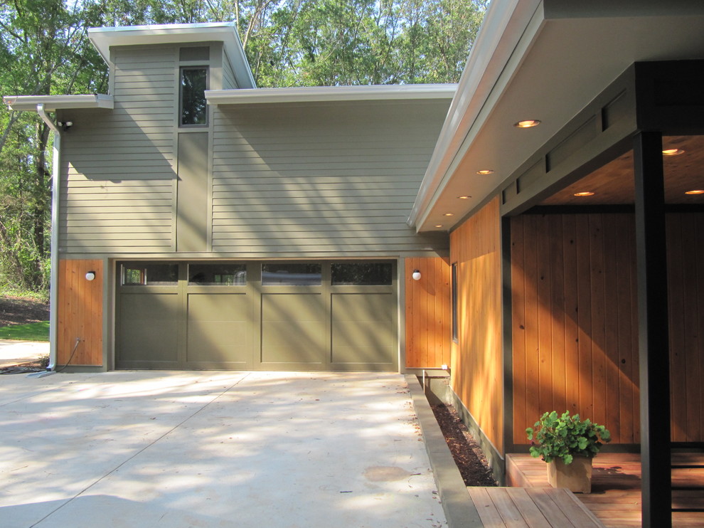 This is an example of a contemporary two-storey green exterior in Atlanta with wood siding.