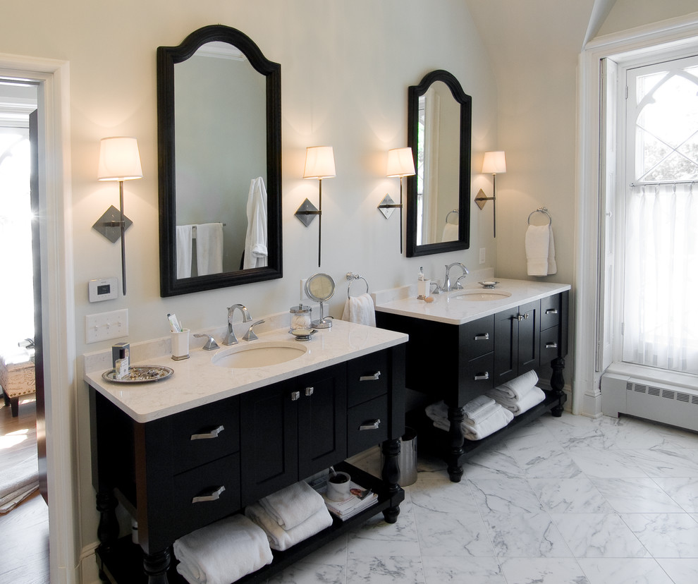 Photo of a large transitional master bathroom in Philadelphia with an undermount sink, recessed-panel cabinets, black cabinets, marble benchtops, marble floors, a two-piece toilet, beige walls, white floor and white benchtops.