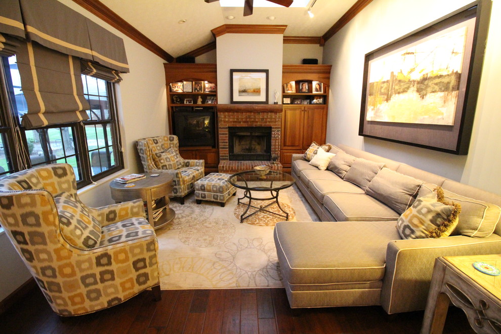 Photo of a mid-sized transitional enclosed family room in Cincinnati with grey walls, carpet, a standard fireplace, a brick fireplace surround and a built-in media wall.