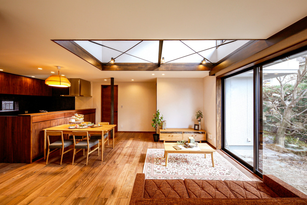Imagen de salón abierto asiático sin chimenea con paredes blancas, suelo de madera en tonos medios y suelo marrón