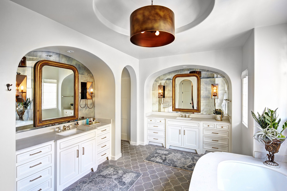 Inspiration for a large mediterranean master bathroom in Dallas with white cabinets, an undermount sink, an undermount tub, white walls, terra-cotta floors, engineered quartz benchtops, gray tile, cement tile and recessed-panel cabinets.