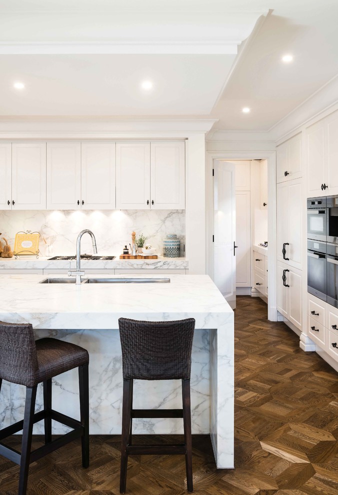 Inspiration for a mid-sized traditional eat-in kitchen in Melbourne with marble splashback and stainless steel appliances.