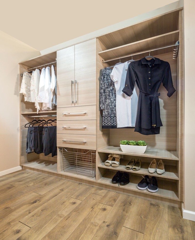 Inspiration for a mid-sized contemporary gender-neutral medium tone wood floor and brown floor walk-in closet remodel in San Diego with flat-panel cabinets and light wood cabinets